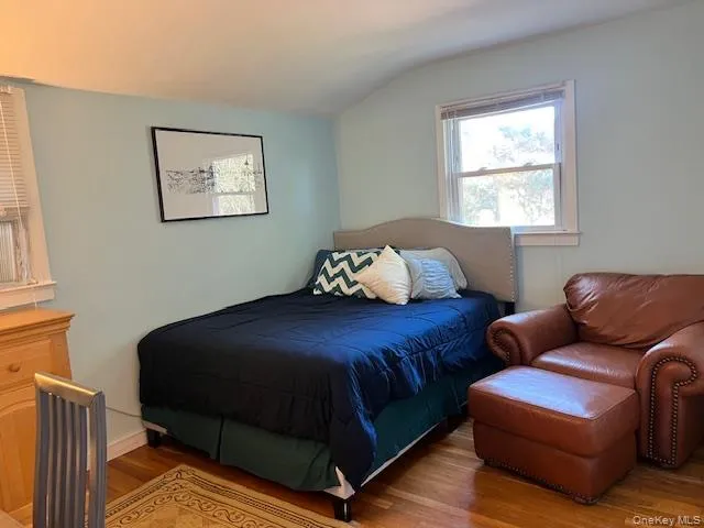 a bedroom with a bed couch and window
