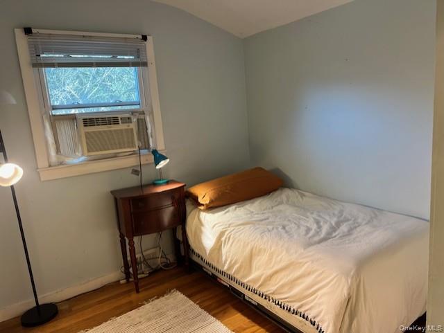 16 Lilac Road Westhampton Beach, NY 11978 - Photo 22 of 25 a bedroom with a bed and a window