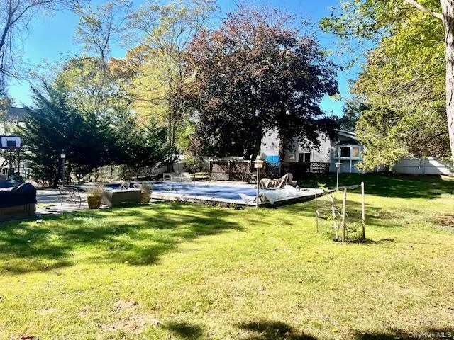 a swimming pool with outdoor seating and yard