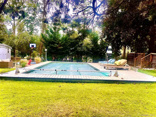 a view of a swimming pool with an outdoor seating and a yard