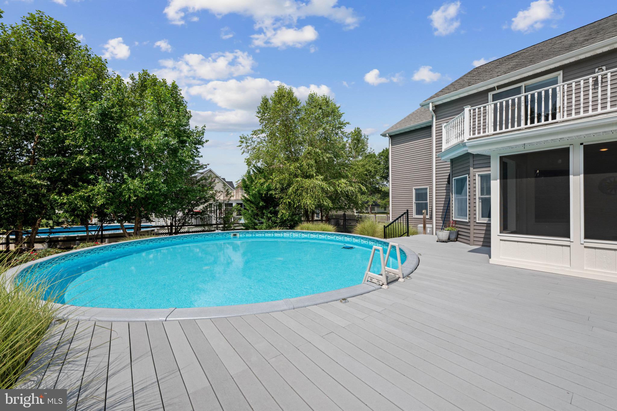 113 Bentons Pleasure Road Chester, MD 21619 - Photo 46 of 53 Serene poolside retreat under blue skies.