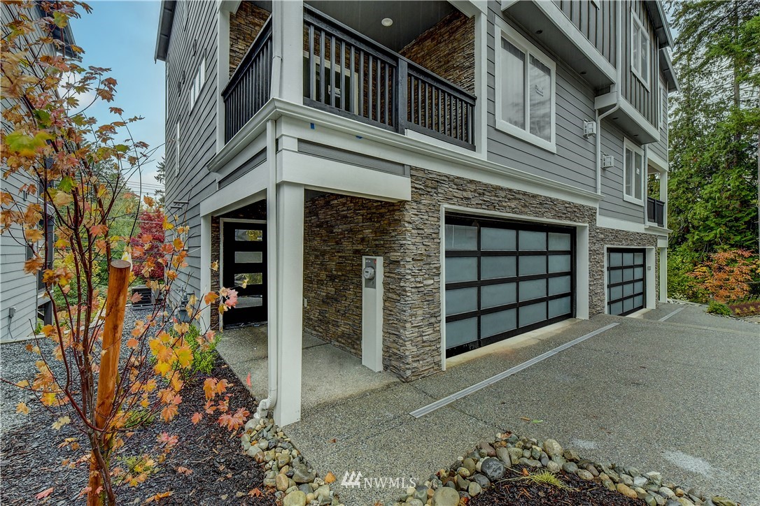 22810 23rd Avenue Southeast, Unit 2 Bothell, WA 98021 - Photo 1 of 16 a view of a house with a yard and garage