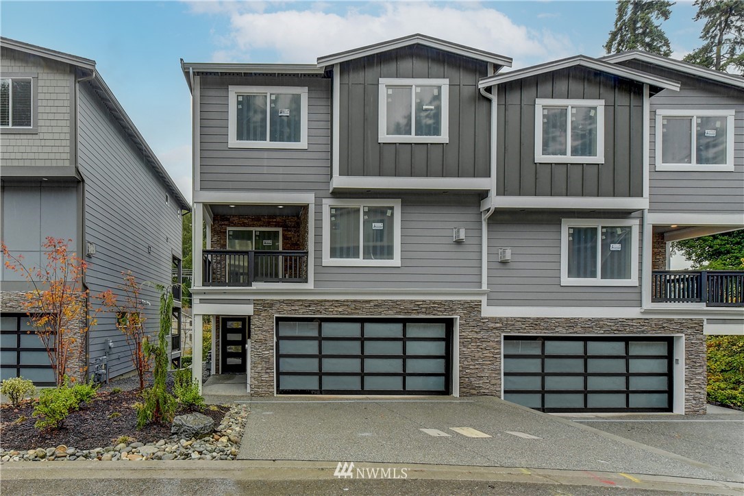 22810 23rd Avenue Southeast, Unit 2 Bothell, WA 98021 - Photo 2 of 16 a front view of a house with a garage