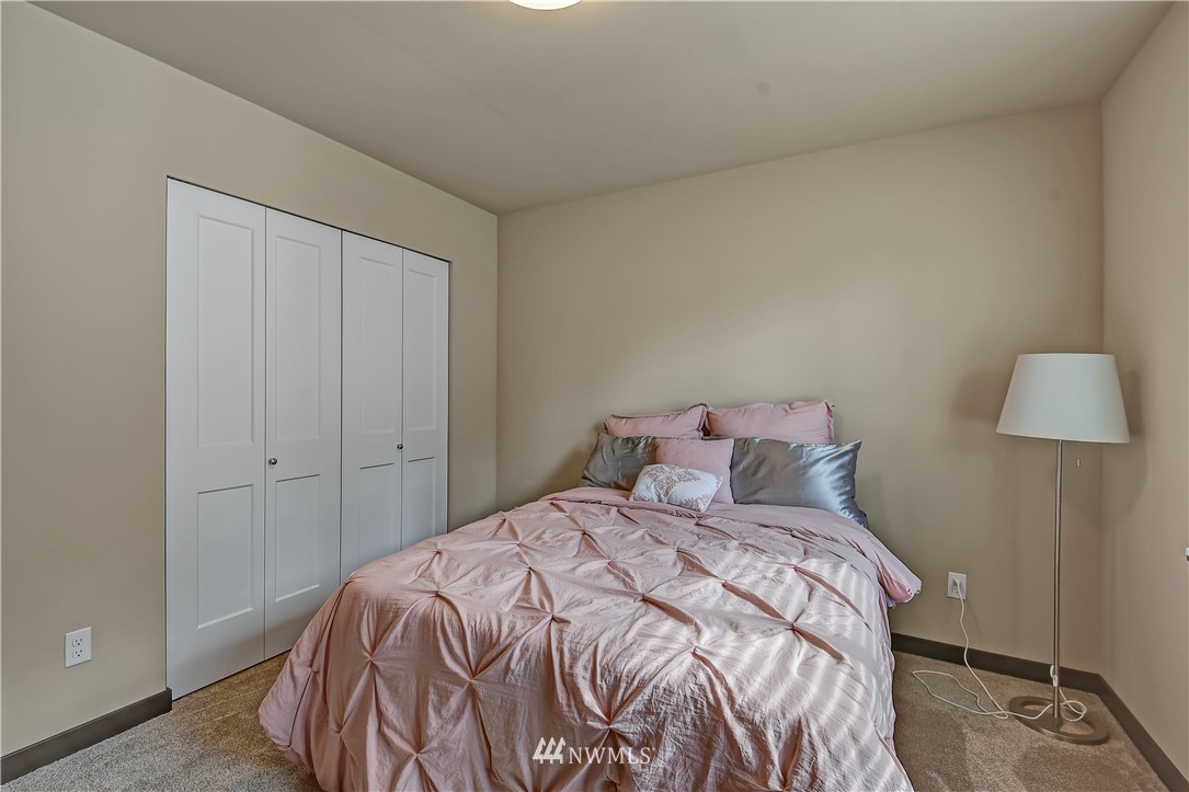 22810 23rd Avenue Southeast, Unit 2 Bothell, WA 98021 - Photo 12 of 16 a bedroom with a bed and a lamp