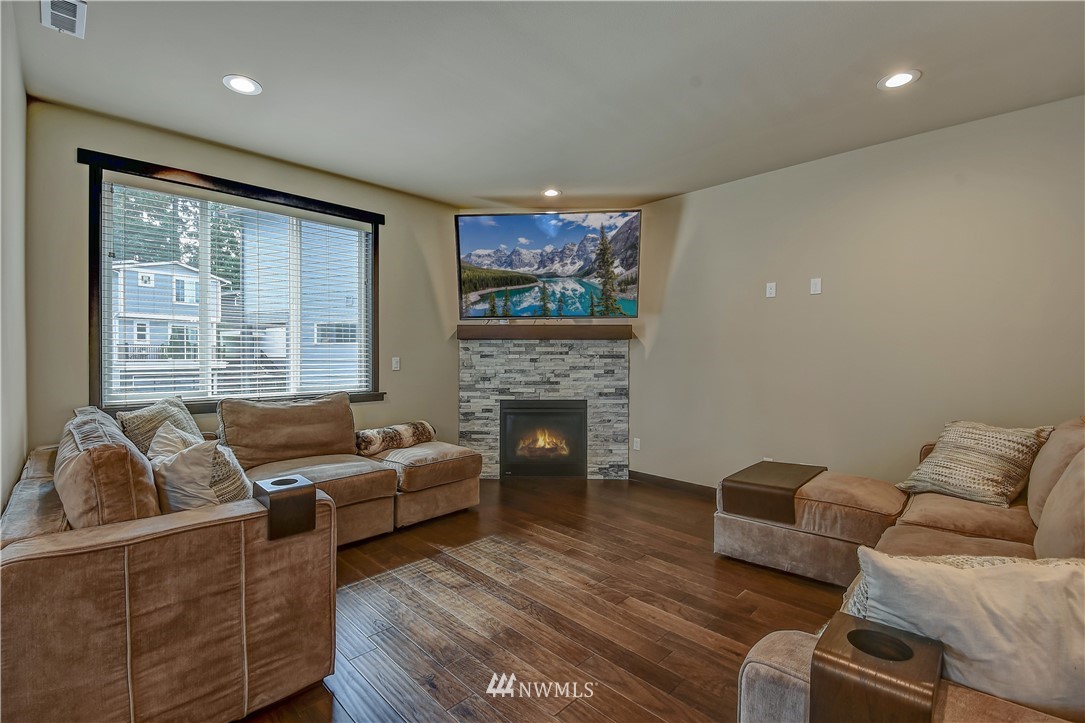 22810 23rd Avenue Southeast, Unit 2 Bothell, WA 98021 - Photo 3 of 16 a living room with furniture and a fireplace