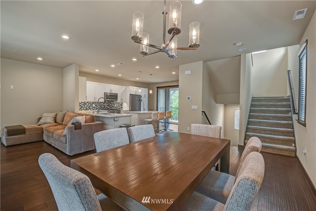 22810 23rd Avenue Southeast, Unit 2 Bothell, WA 98021 - Photo 8 of 16 a living room with furniture and a chandelier