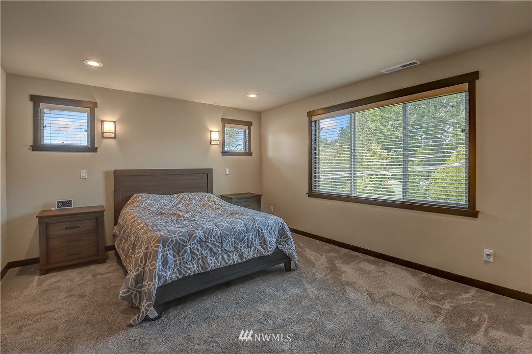 22810 23rd Avenue Southeast, Unit 2 Bothell, WA 98021 - Photo 9 of 16 a bedroom with a bed and a window