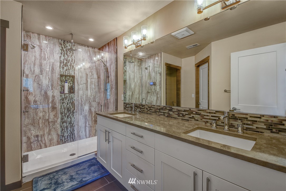 22810 23rd Avenue Southeast, Unit 2 Bothell, WA 98021 - Photo 10 of 16 a bathroom with a double vanity sink and a mirror