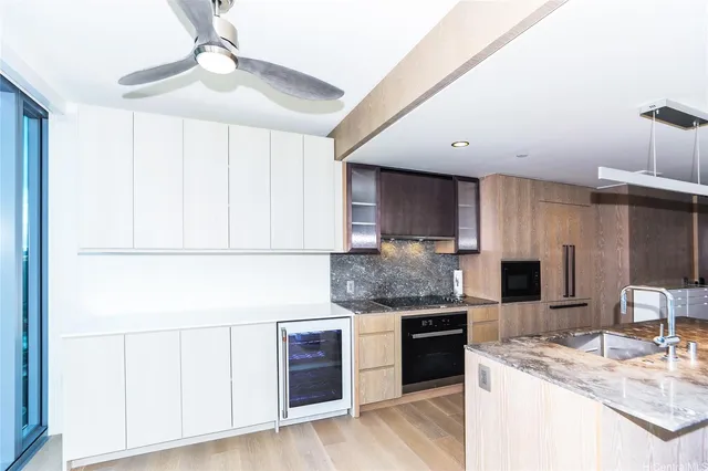 a kitchen with stainless steel appliances granite countertop a sink and a refrigerator