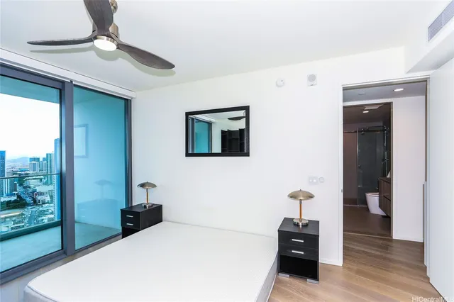 a bedroom with a bed and a chandelier