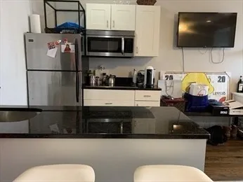 a bathroom with a toilet a sink and a mirror