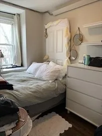 a bedroom with a bed and a window