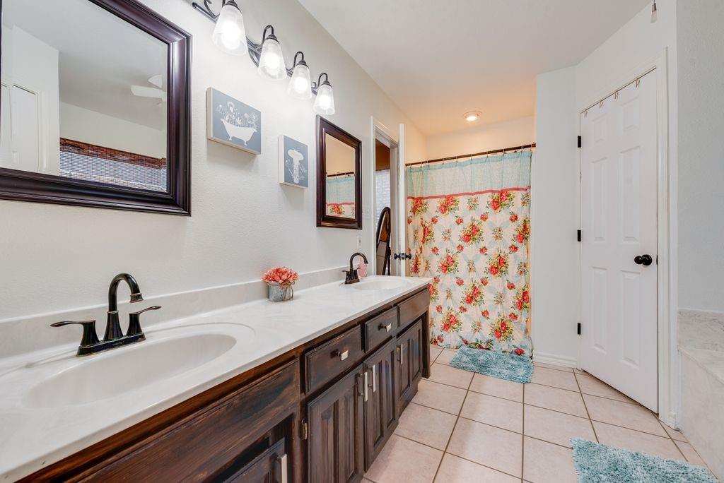 579 South Hitt Street Boyd, TX 76023 - Photo 26 of 34 Large bathroom with Garden Jetted Tub, dual sinks, and stand up separate shower