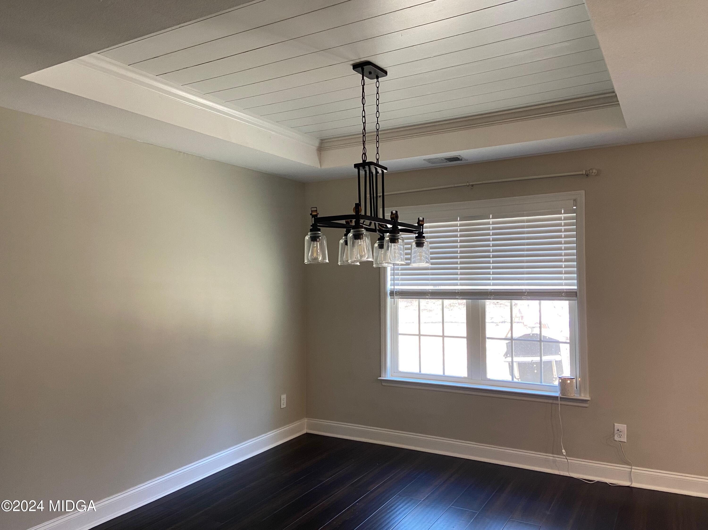 461 Schofill Road Fort Valley, GA 31030 - Photo 12 of 24 a view of a room with wooden floor a ceiling fan and windows