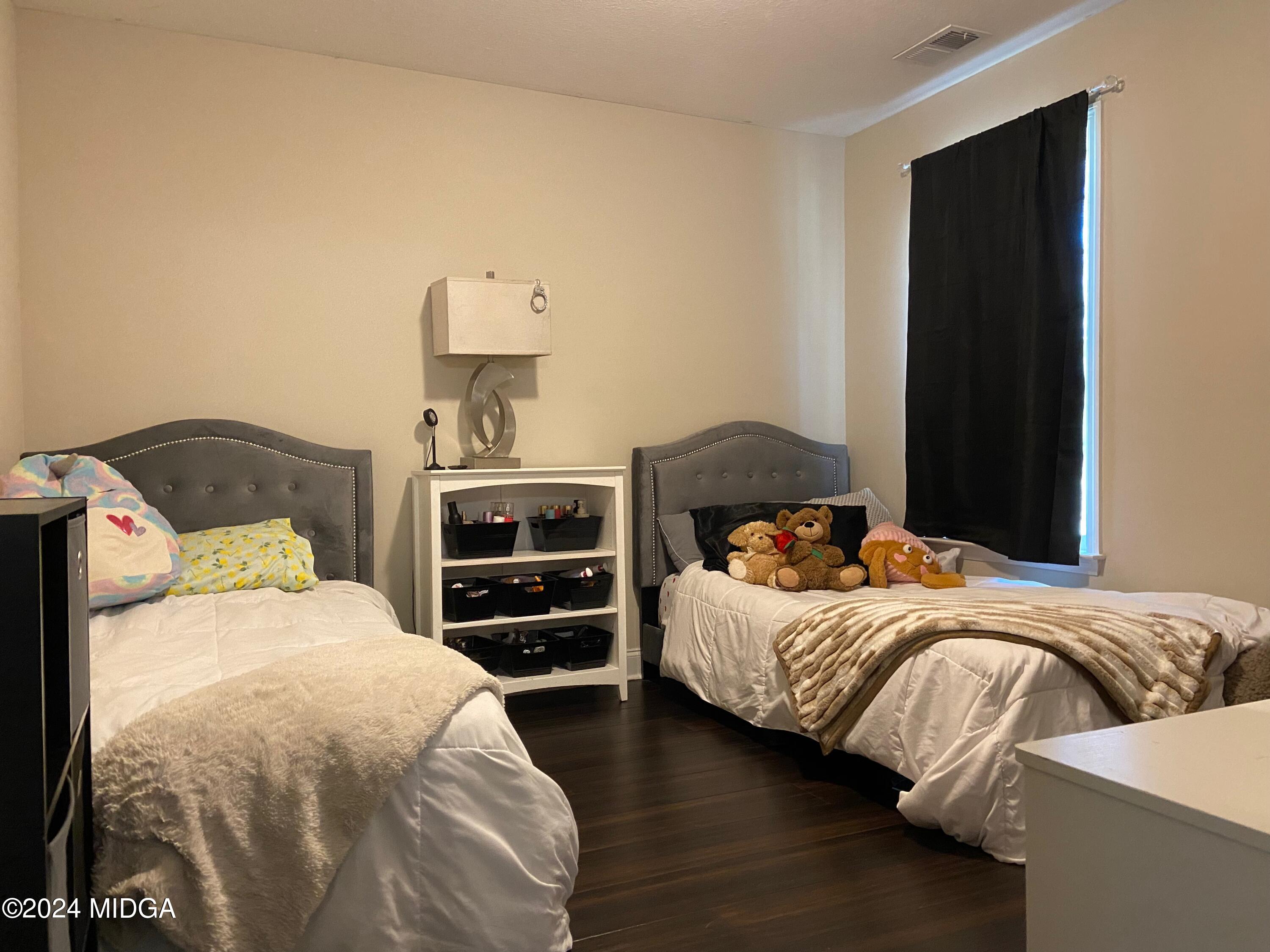 461 Schofill Road Fort Valley, GA 31030 - Photo 21 of 24 a bedroom with a bed and dresser