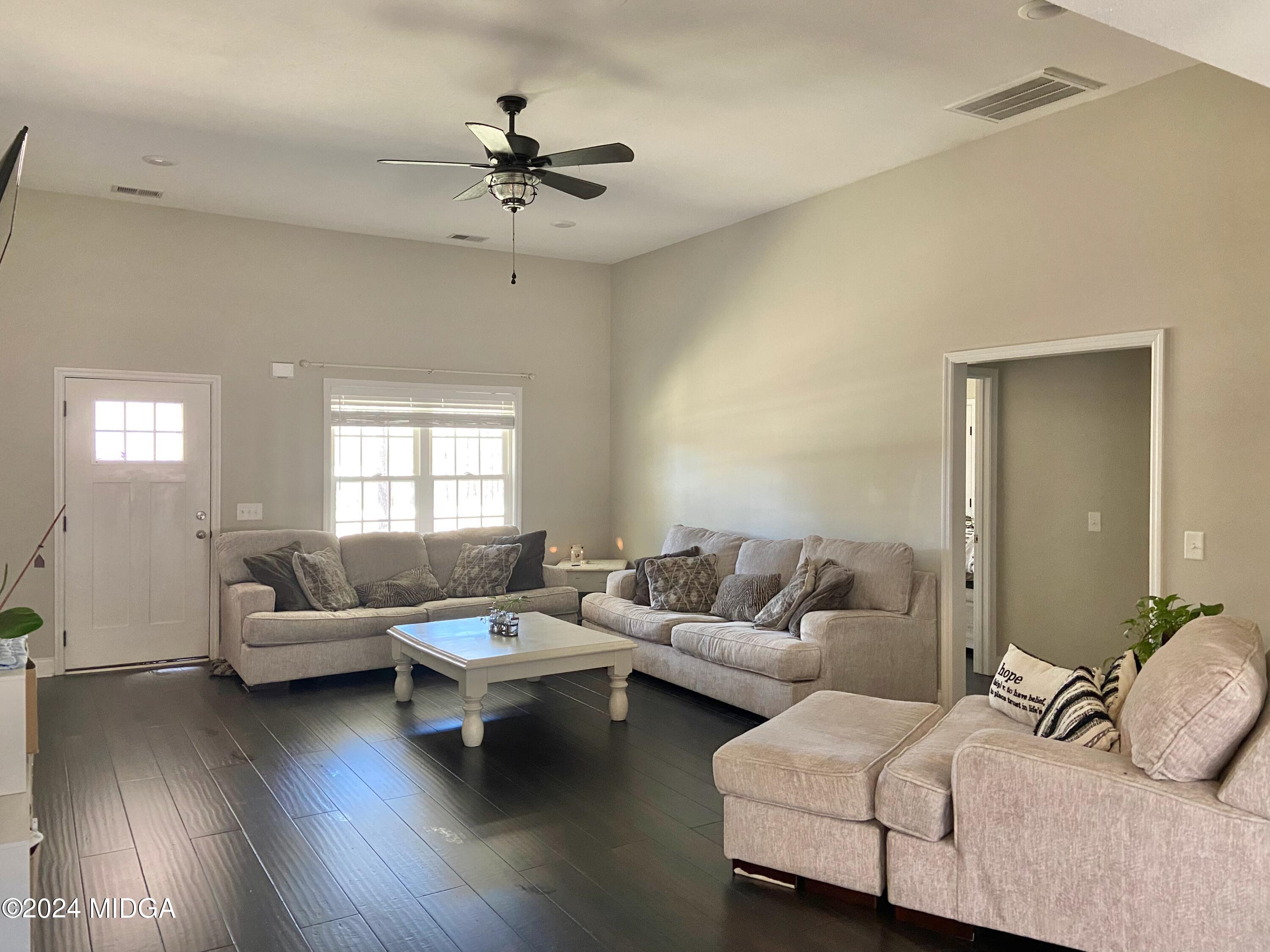 461 Schofill Road Fort Valley, GA 31030 - Photo 5 of 24 a living room with furniture and a wooden floor