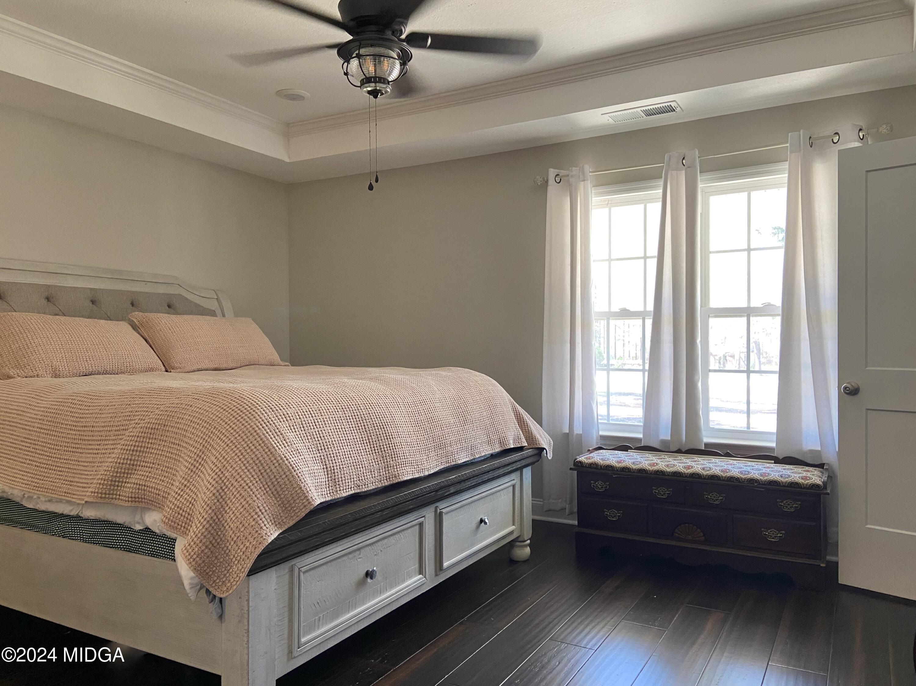 461 Schofill Road Fort Valley, GA 31030 - Photo 8 of 24 a spacious bedroom with a bed and a window