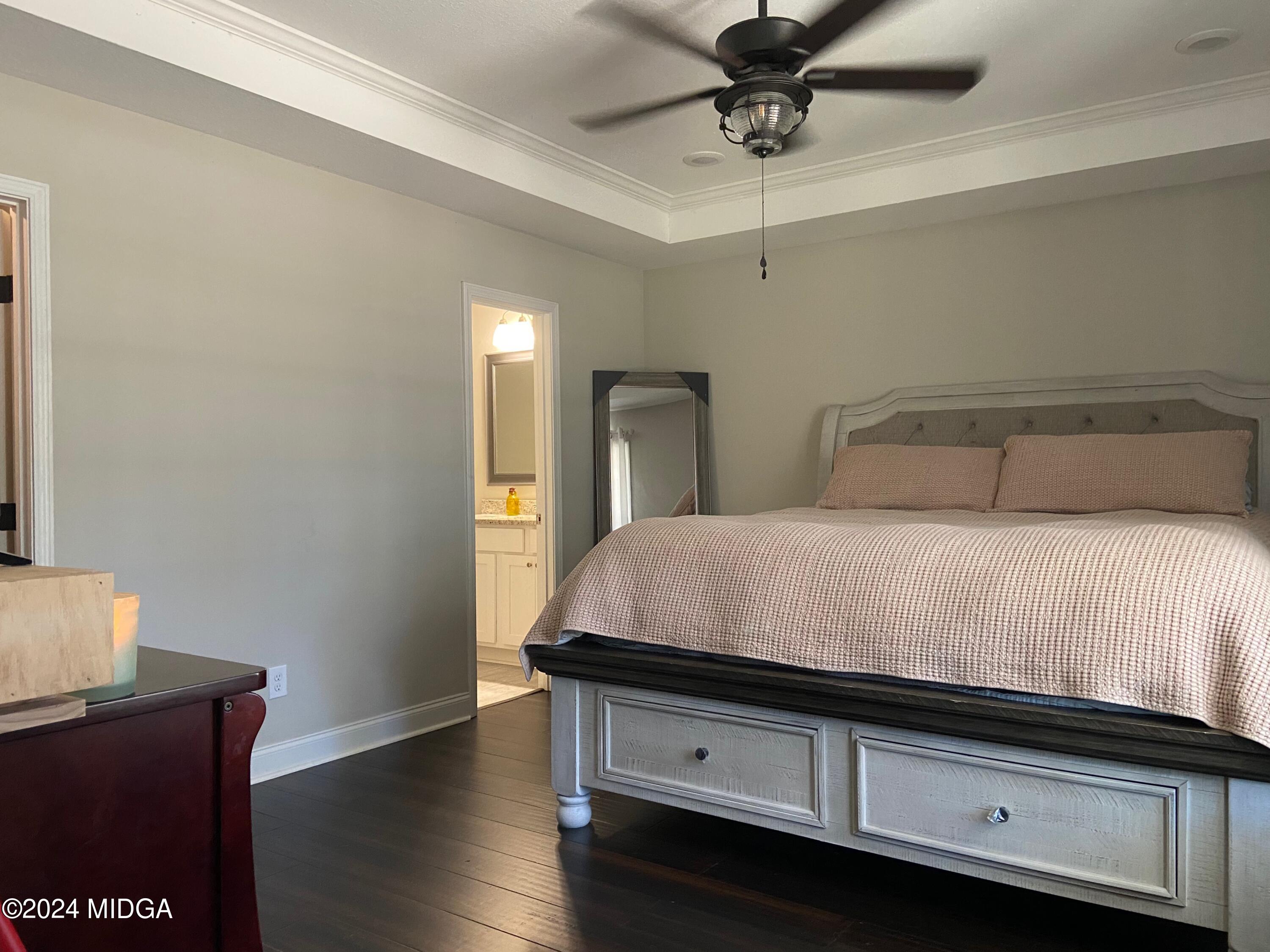 461 Schofill Road Fort Valley, GA 31030 - Photo 9 of 24 a bedroom with a bed and wooden floor