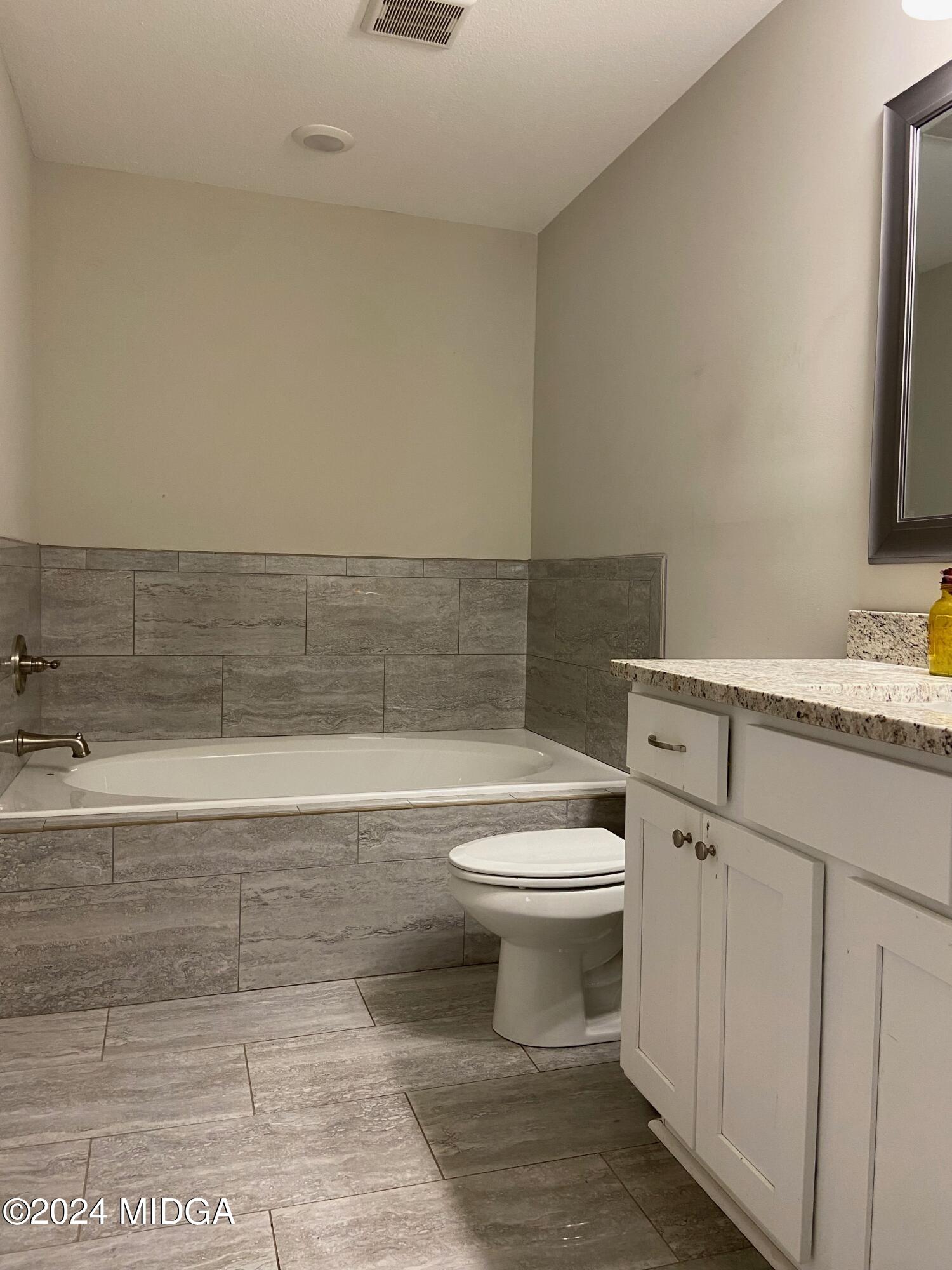 461 Schofill Road Fort Valley, GA 31030 - Photo 10 of 24 a bathroom with a toilet a sink a vanity and mirror