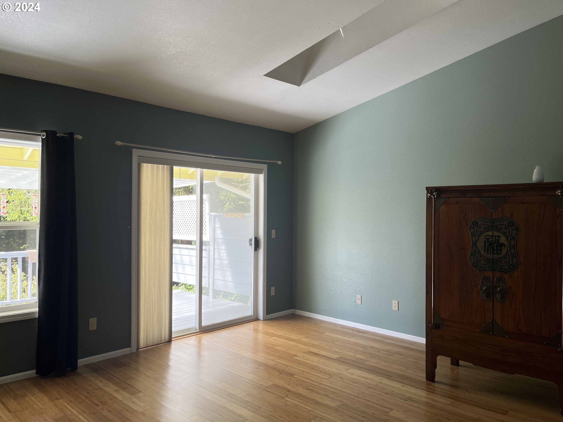 83480 Clear Lake Road Florence, OR 97439 - Photo 15 of 48 an empty room with wooden floor and windows