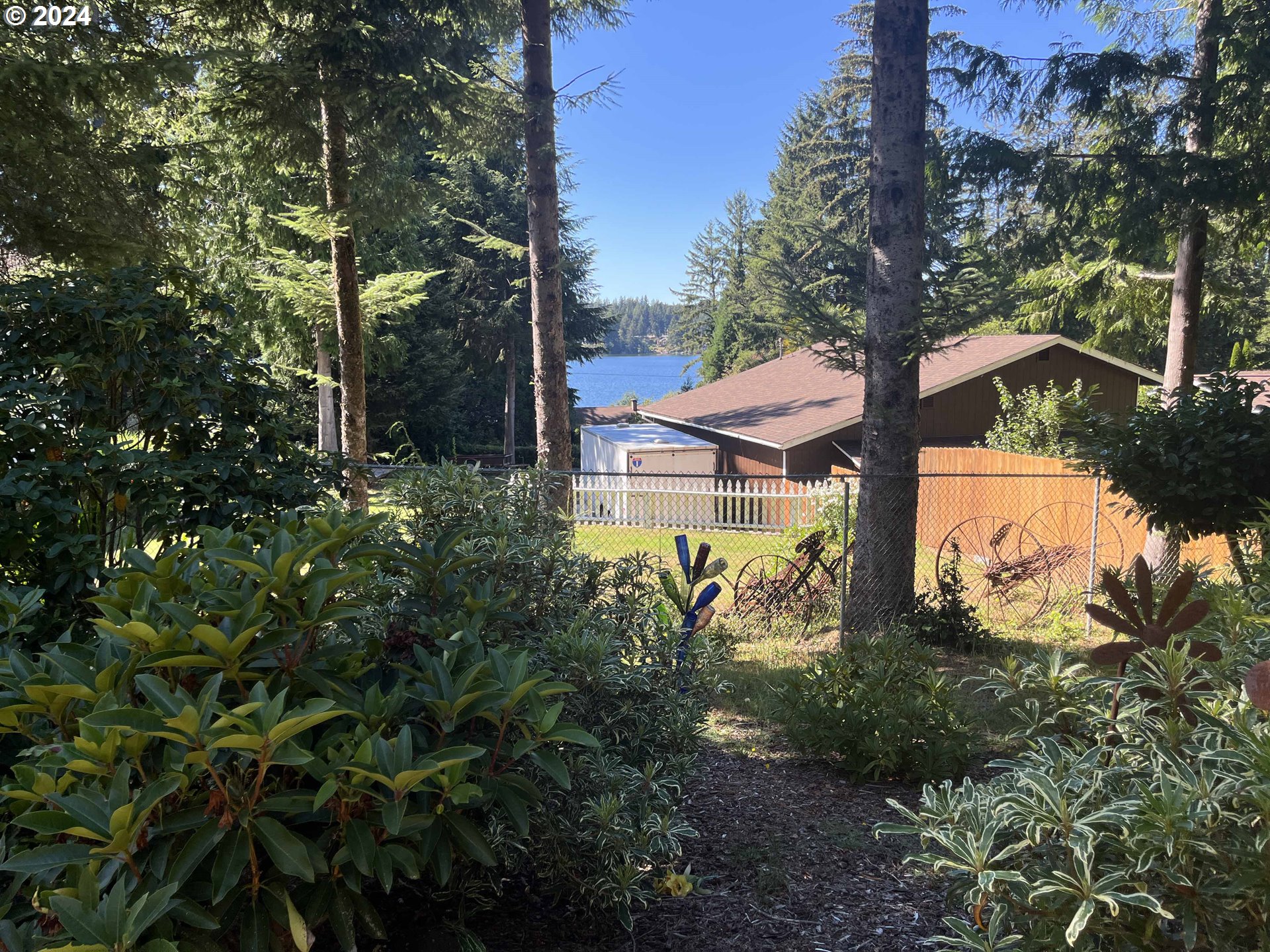 83480 Clear Lake Road Florence, OR 97439 - Photo 38 of 48 a backyard of a house with lots of green space