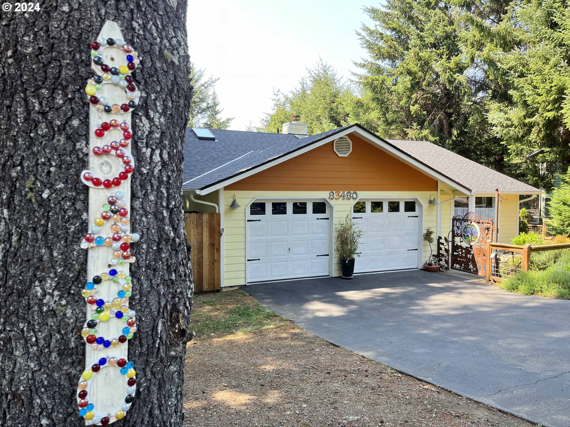 83480 Clear Lake Road Florence, OR 97439 - Photo 4 of 48 a front view of a house with a garage
