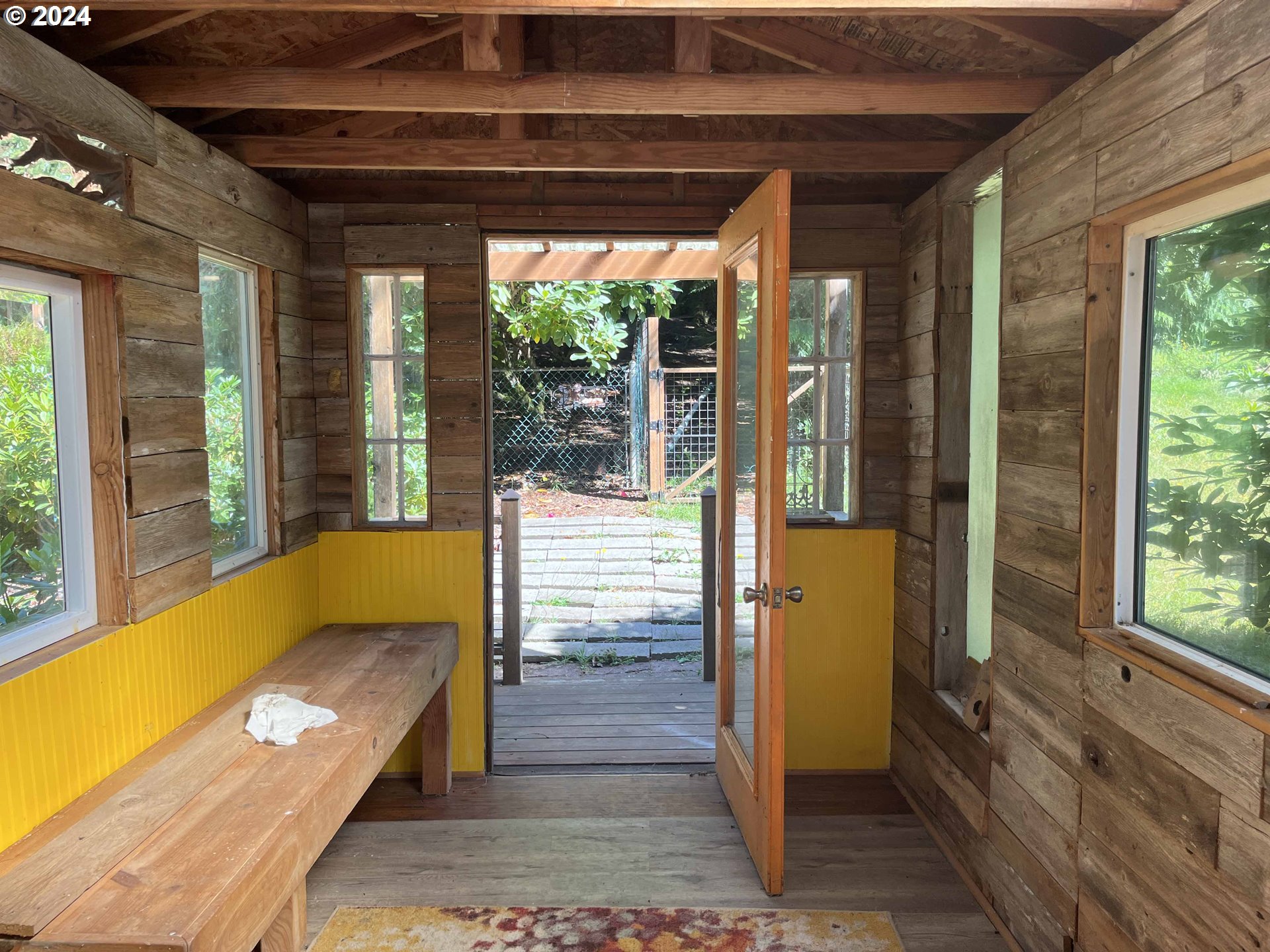 83480 Clear Lake Road Florence, OR 97439 - Photo 42 of 48 a view of a porch with a table and chairs