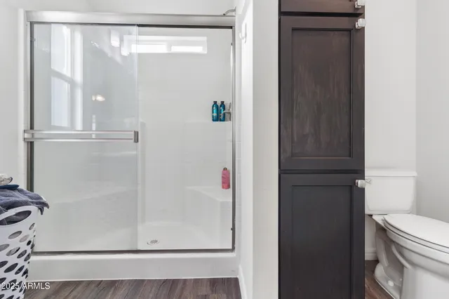 a bathroom with a shower a toilet and sink