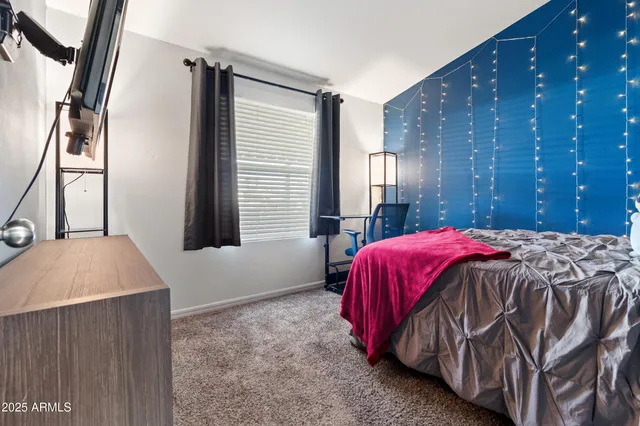 a bed room with a bed and a chair