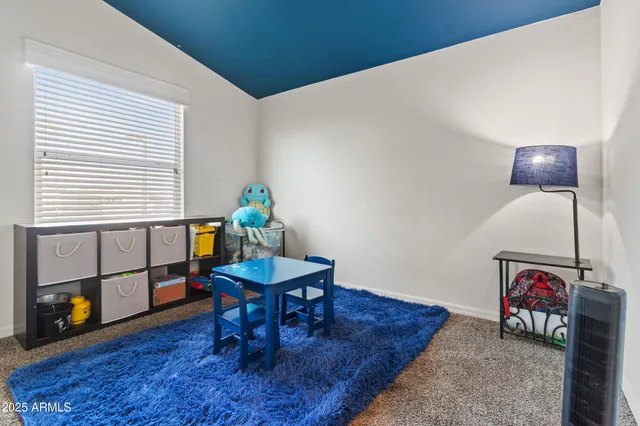 a living room with furniture and a dining table