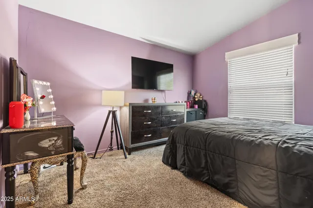 a bedroom with a bed and a mirror