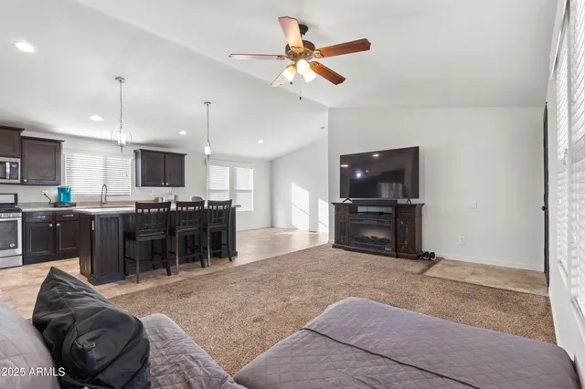 a living room with furniture and kitchen view