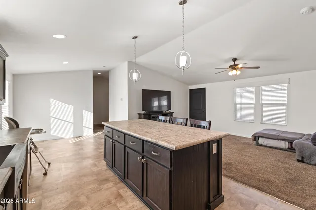 a large kitchen with kitchen island a large island in it