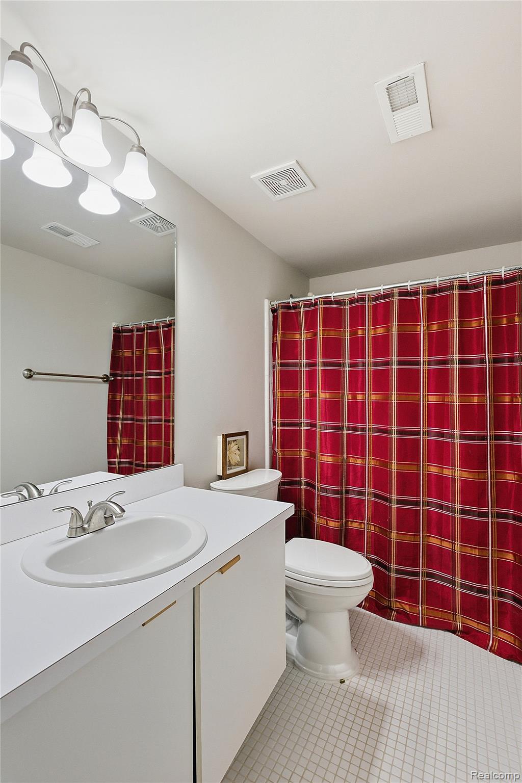7154 Westchester Road West Bloomfield, MI 48322 - Photo 13 of 38 Bathroom with vanity, a shower with shower curtain, and light tile patterned floors