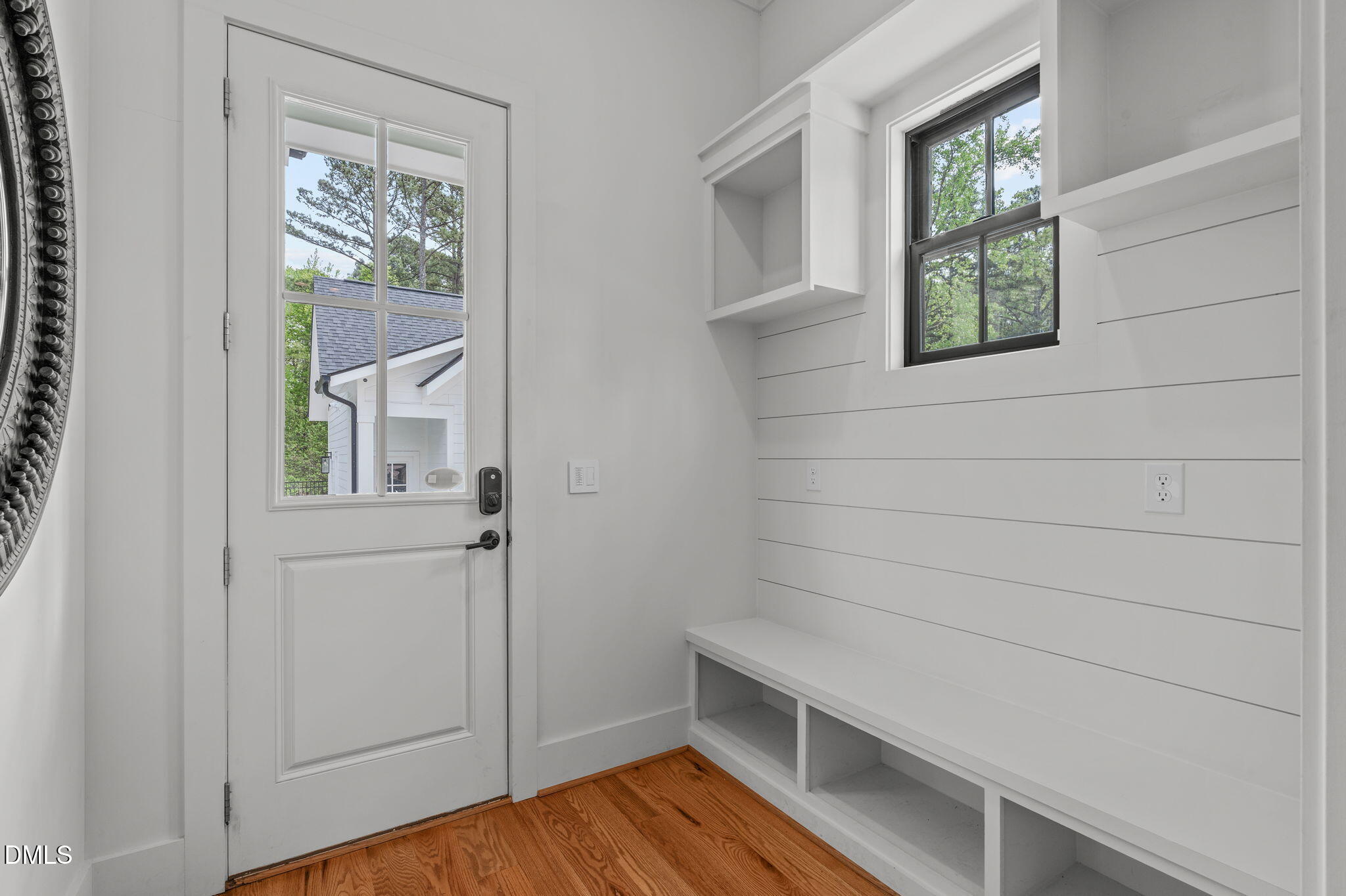 5005 Ten-Ten Road Apex, NC 27539 - Photo 15 of 60 Entry area from detached garage and driveway entrance. Shiplap wall detail with cubbies for convenient drop zone organization.
