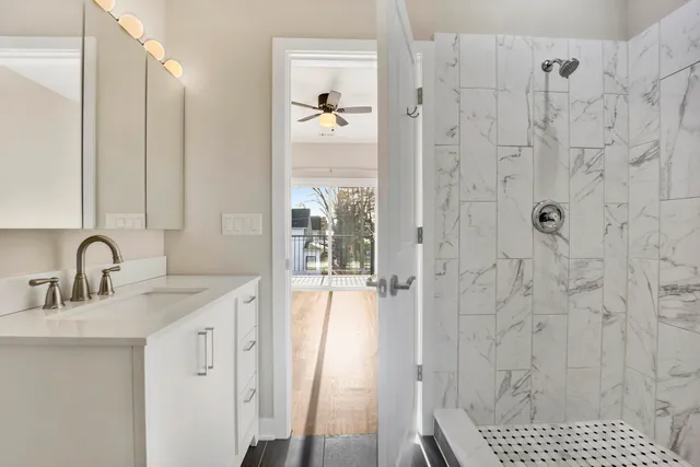 a bathroom with a sink a shower and a mirror