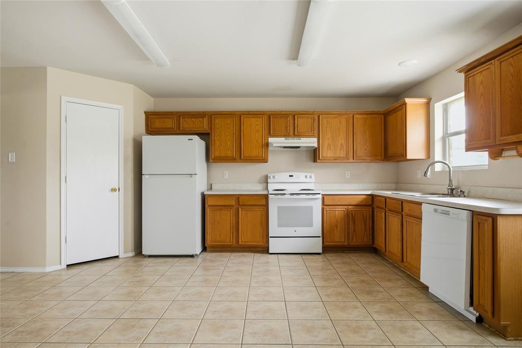 100 Pinnacle Circle Aledo, TX 76008 - Photo 11 of 30 a kitchen with a refrigerator sink and cabinets