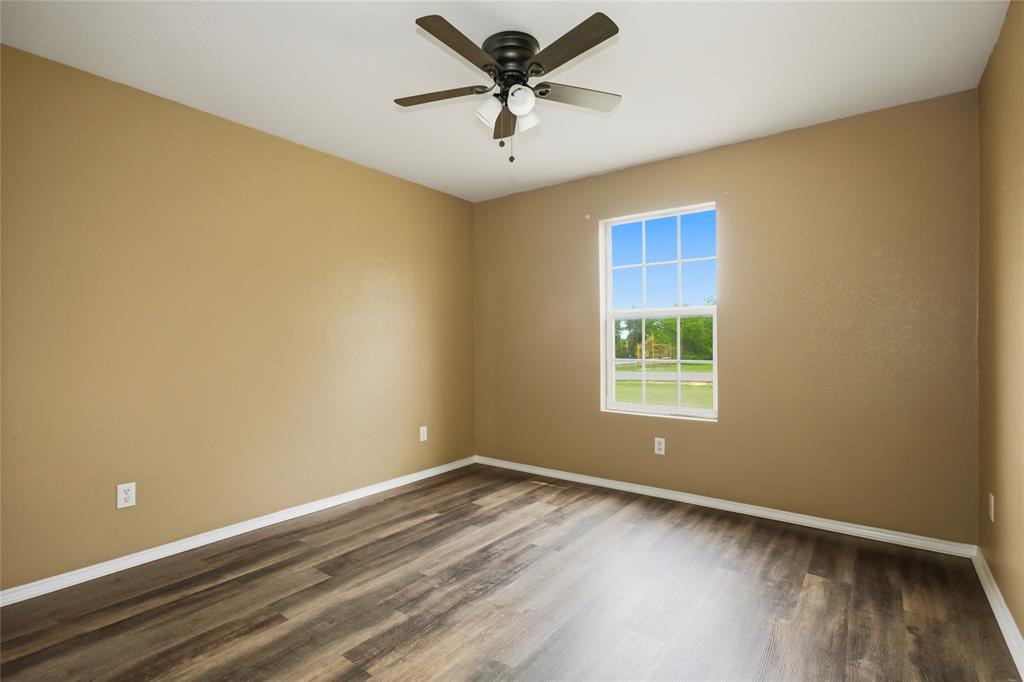100 Pinnacle Circle Aledo, TX 76008 - Photo 24 of 30 a view of a room with wooden floor and a ceiling fan