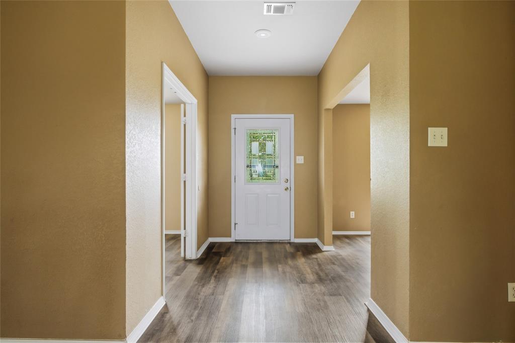 100 Pinnacle Circle Aledo, TX 76008 - Photo 5 of 30 an empty room with wooden floor and entrance