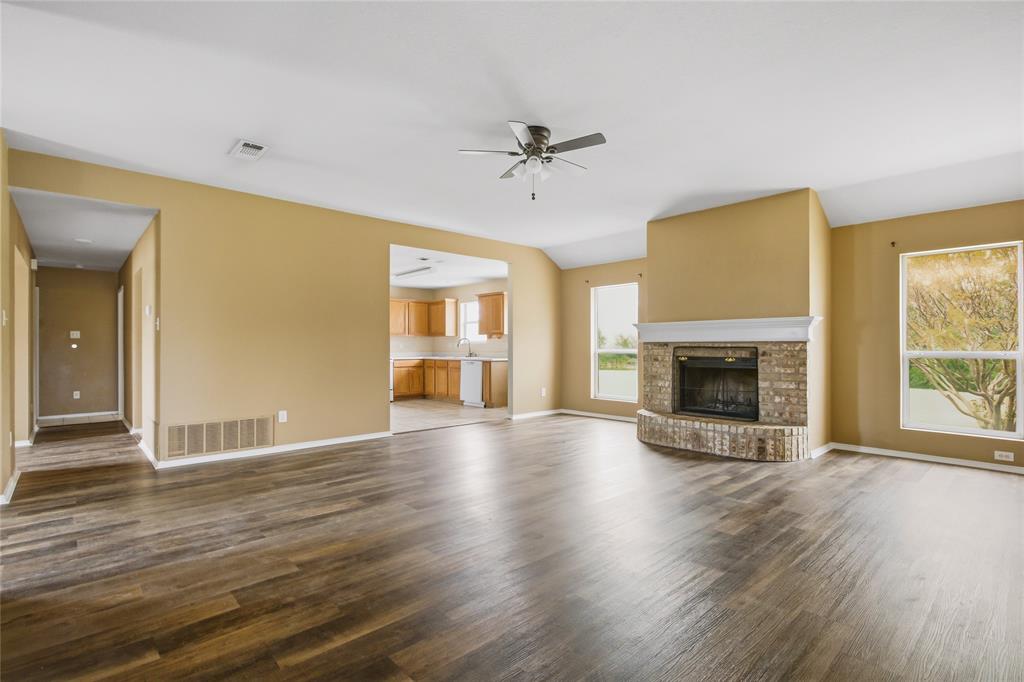 100 Pinnacle Circle Aledo, TX 76008 - Photo 10 of 30 an empty room with wooden floor fireplace and windows