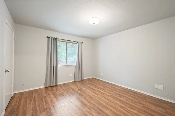 a view of a porch with furniture and wooden floor