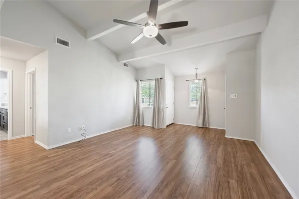 wooden floor in an empty room with a window