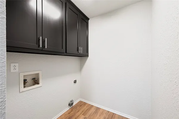 an empty room with wooden floor a ceiling fan and closet area