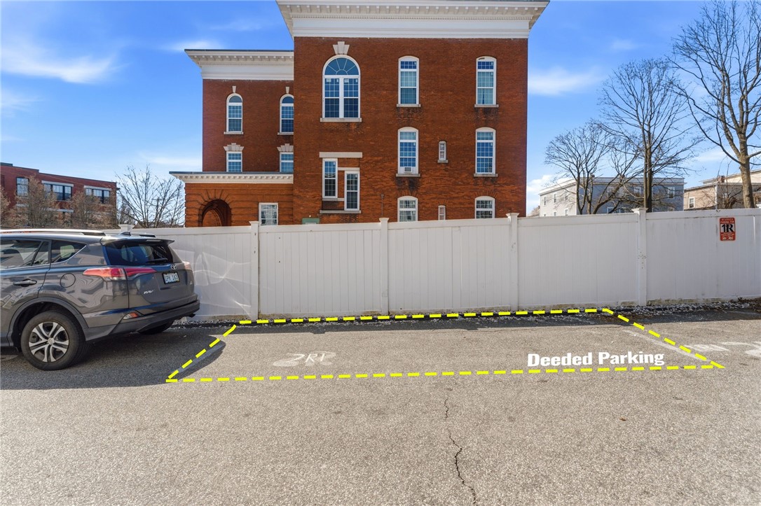 736 Social Street, Unit 2R Woonsocket, RI 02895 - Photo 23 of 24 2 deeded parking spaces, 1 on fence, the 2nd behind the buiilding