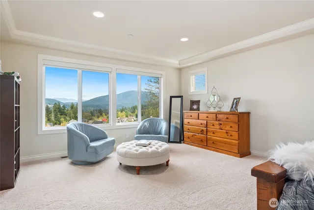 a living room with furniture and a floor to ceiling window