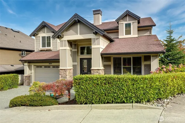a front view of a house with a garden
