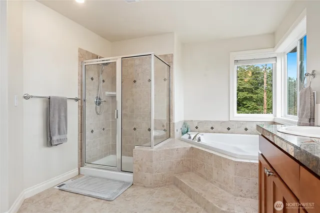a spacious bathroom with a tub shower sink and mirror