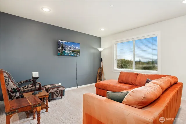 a blue couch sitting in a living room next to a window