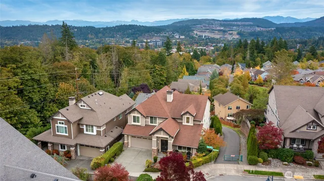 an aerial view of residential houses with outdoor space and river