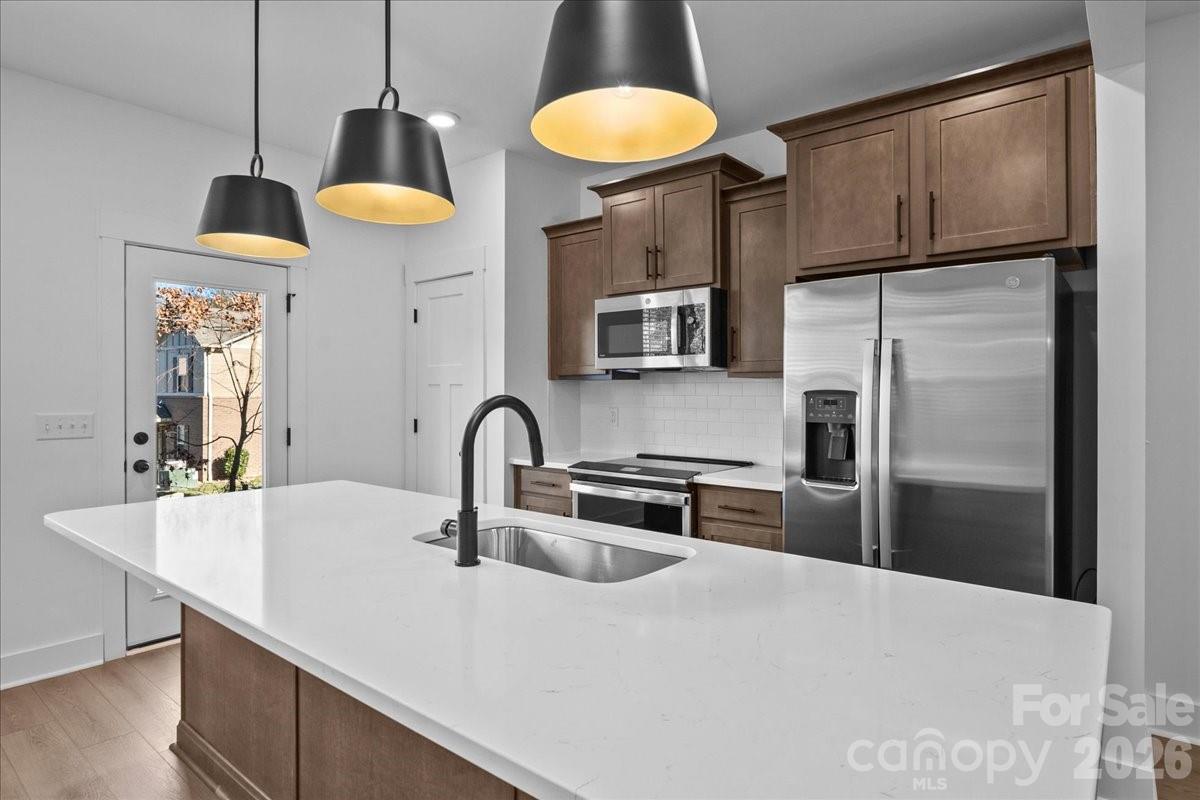 47 Moon Hvn Way Arden, NC 28704 - Photo 4 of 30 a kitchen with stainless steel appliances a sink a refrigerator and a counter top space